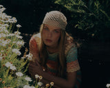 Model wearing a crochet hat from the Sun Diaries collection by SER by Andrea Agudelo