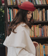 Woman wearing a handmade red pillbox hat